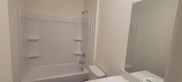 a bathroom with a bathtub and a toilet