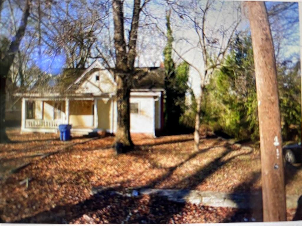 856 Mildred Place Northwest Atlanta, GA 30318 - Photo 1 of 1 a view of a house with a yard tree and wooden fence