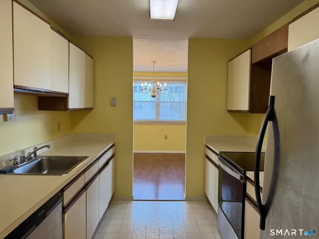 a kitchen with a sink cabinets and appliances