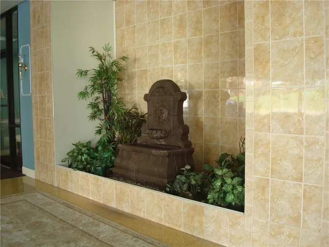 a living room with furniture and a lamp