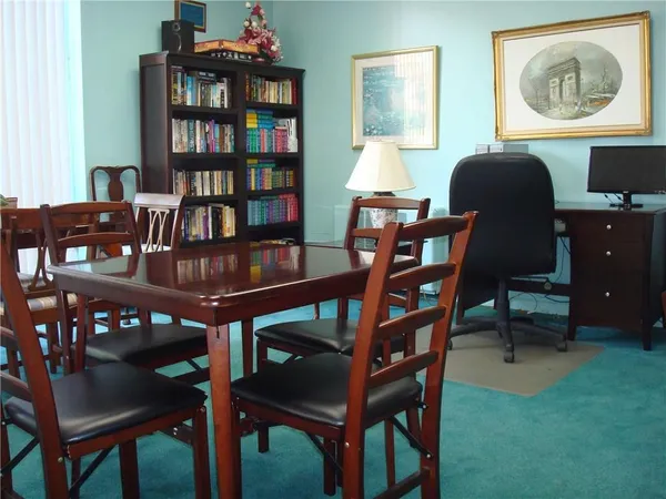 a kitchen with a table chairs sink and cabinets