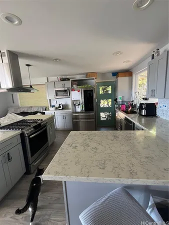 a kitchen with a stove a refrigerator and a stove