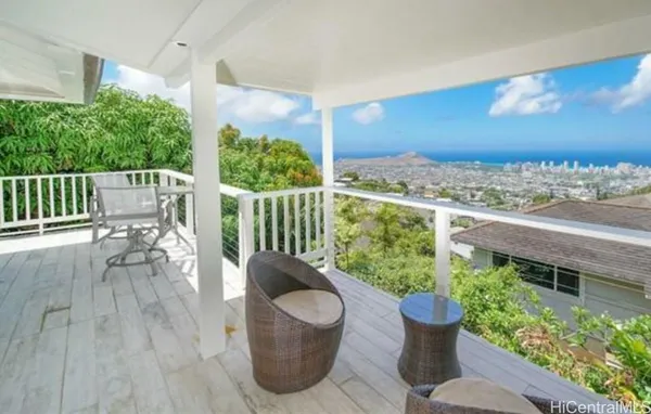 a view of a balcony with chair and potted plant