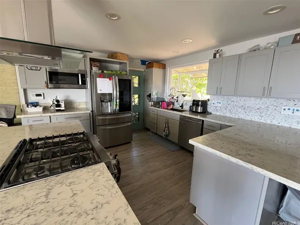 a kitchen with sink stove and refrigerator