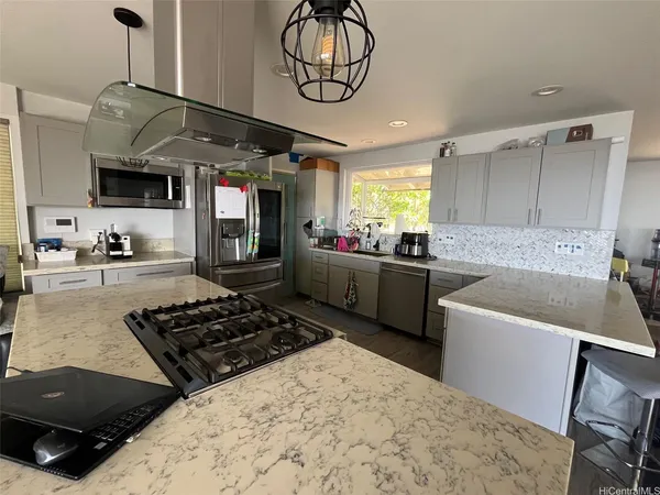 a kitchen with a stove a sink and a refrigerator