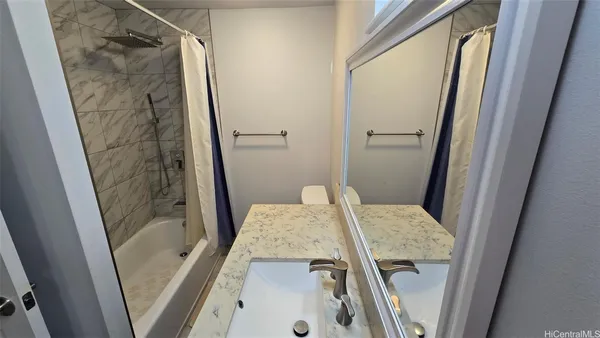 a bathroom with a tub and shower