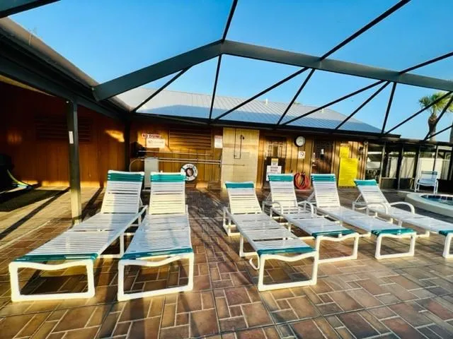a view of a patio with table and chairs under an umbrella
