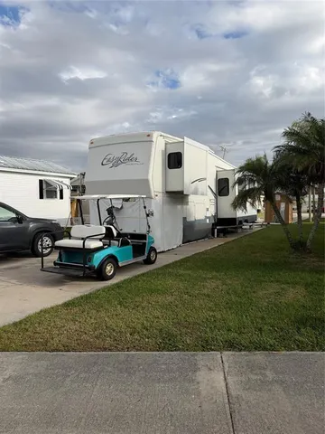 a view of a yard with cars parked
