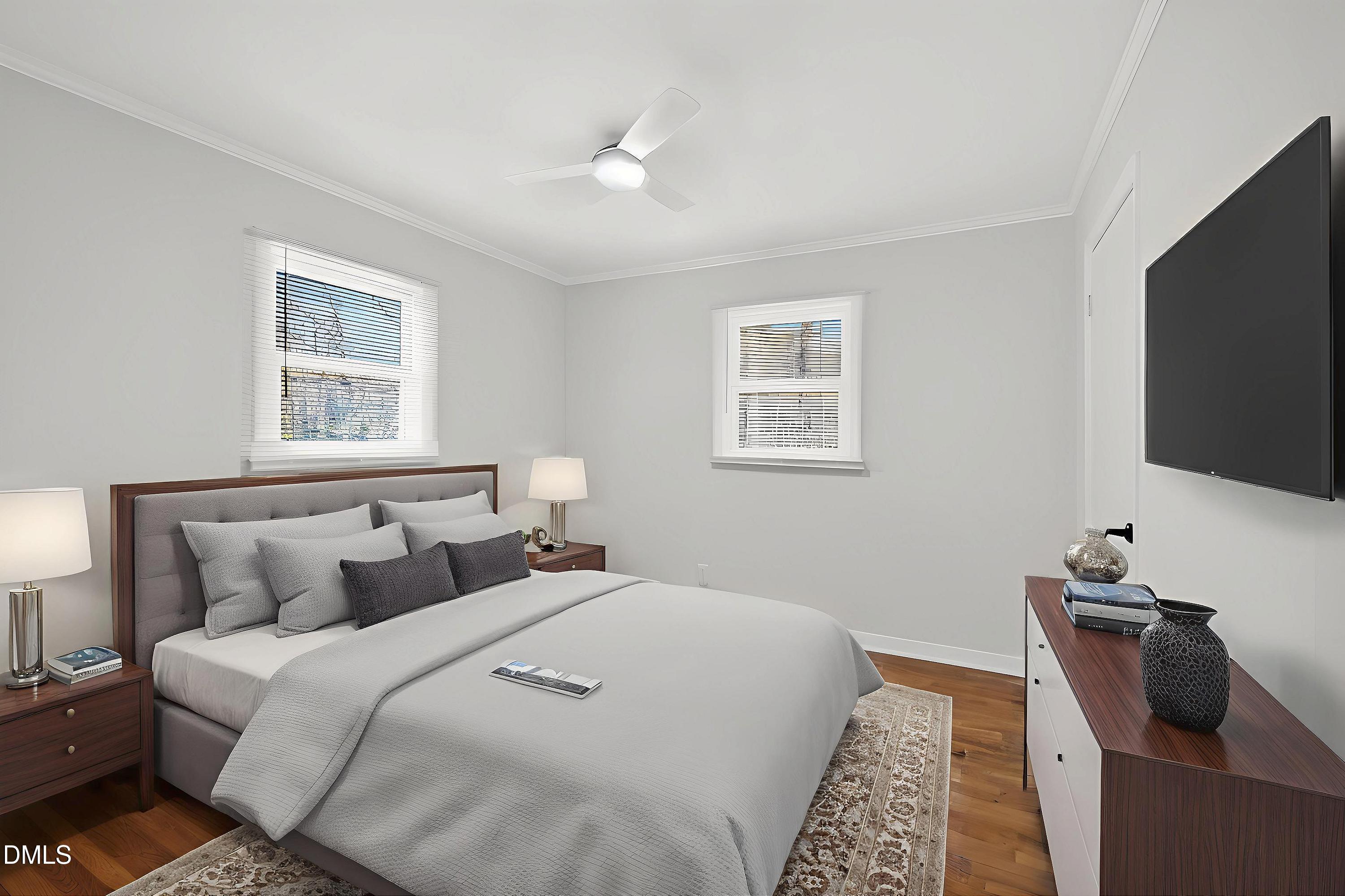302 Normandy Street Durham, NC 27707 - Photo 21 of 29 a bedroom with a bed and a flat screen tv