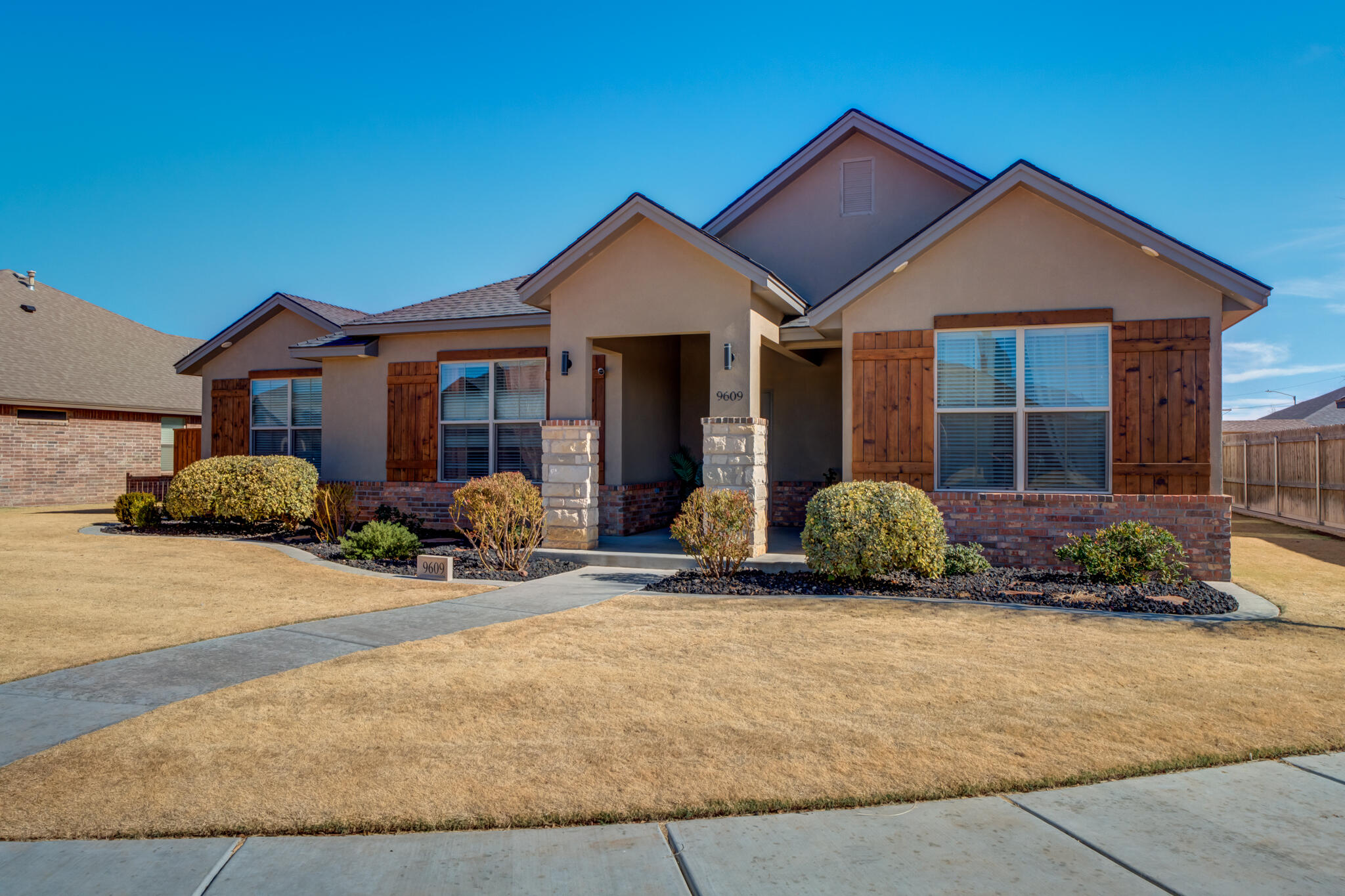 9609 Inverness Avenue Lubbock, TX 79424 - Photo 1 of 17 a front view of a house with a yard