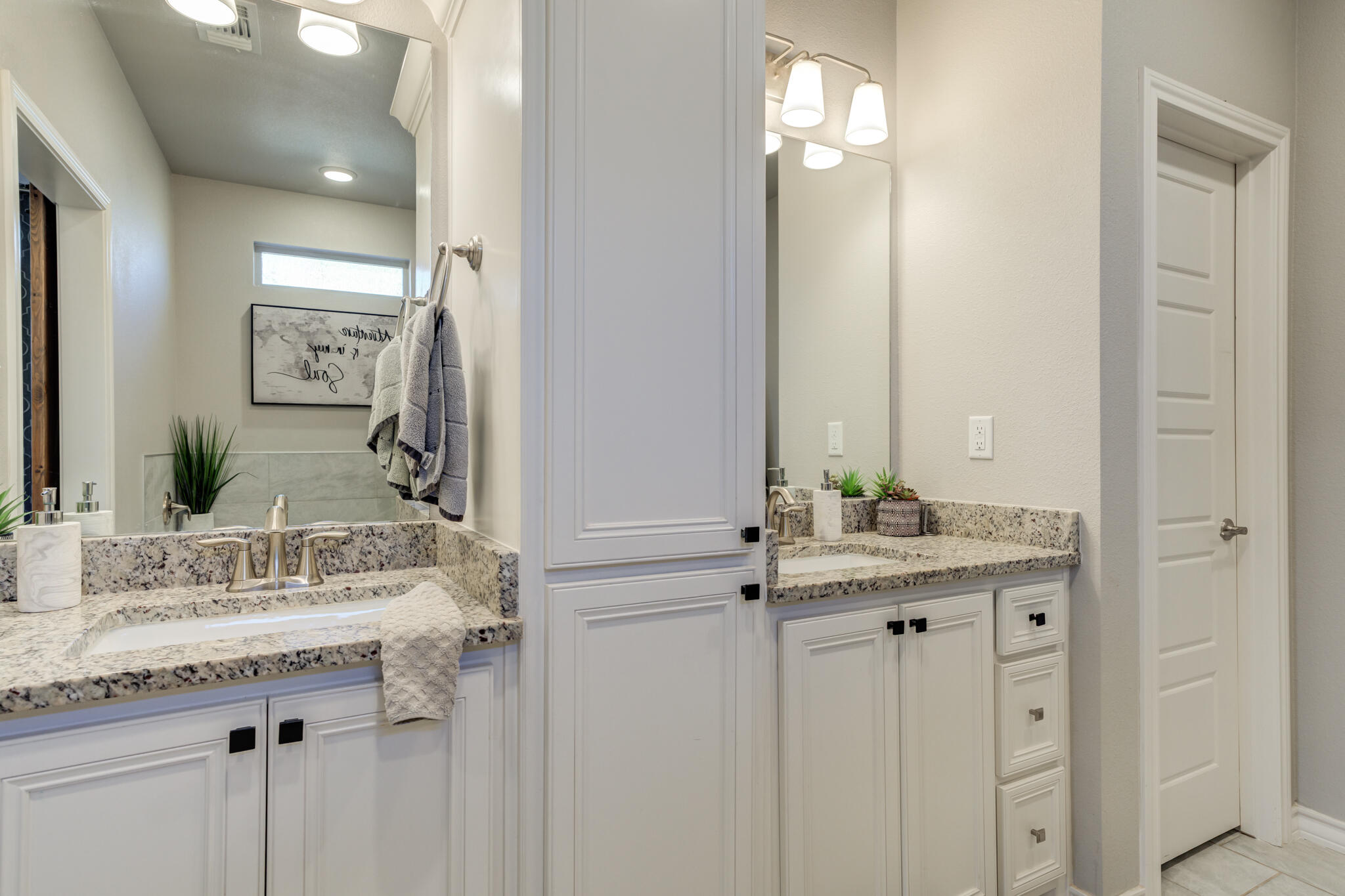 9609 Inverness Avenue Lubbock, TX 79424 - Photo 15 of 17 a bathroom with a granite countertop sink and a mirror
