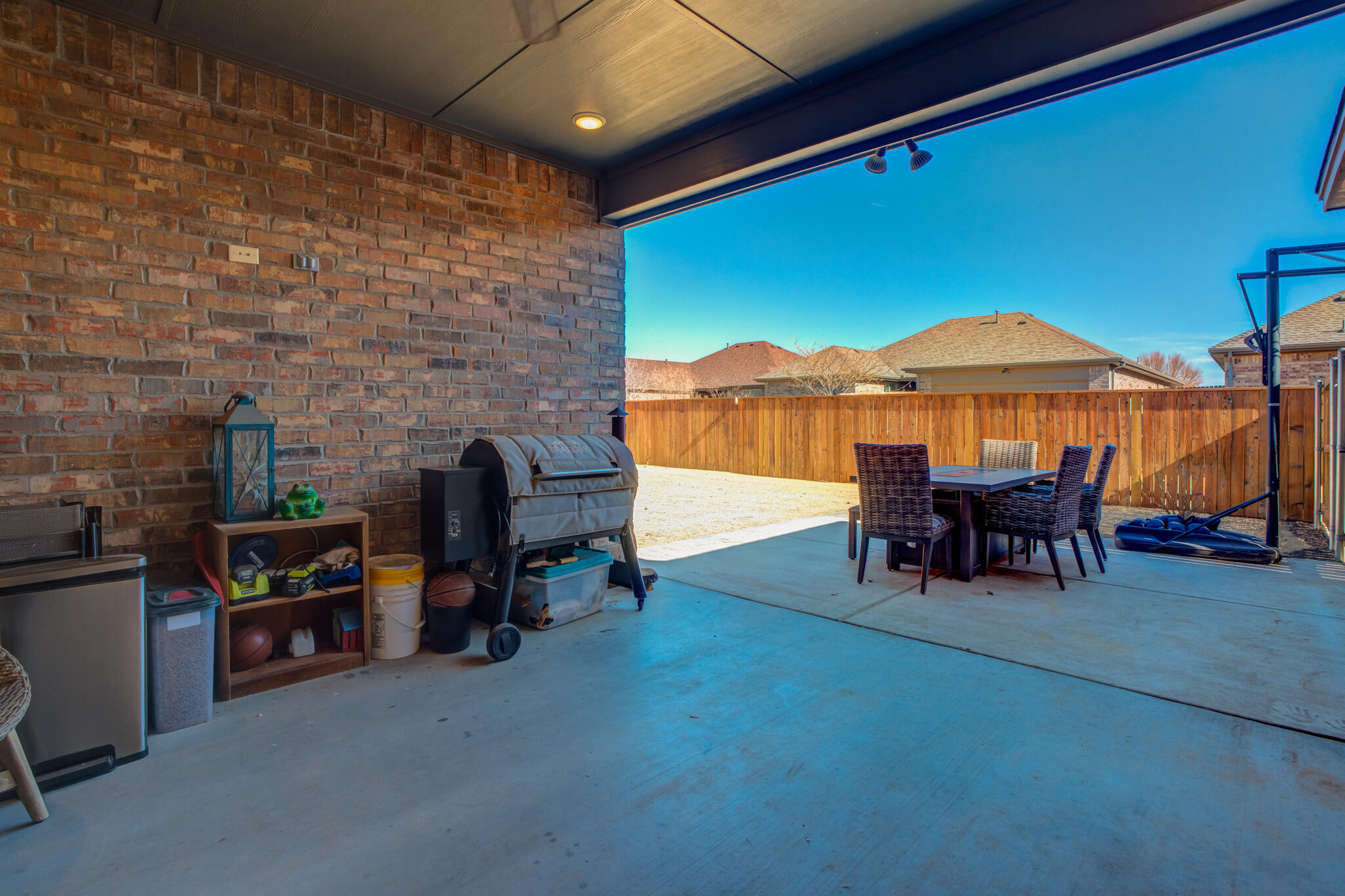 9609 Inverness Avenue Lubbock, TX 79424 - Photo 16 of 17 a view of a chairs and table in the patio and a wooden fence