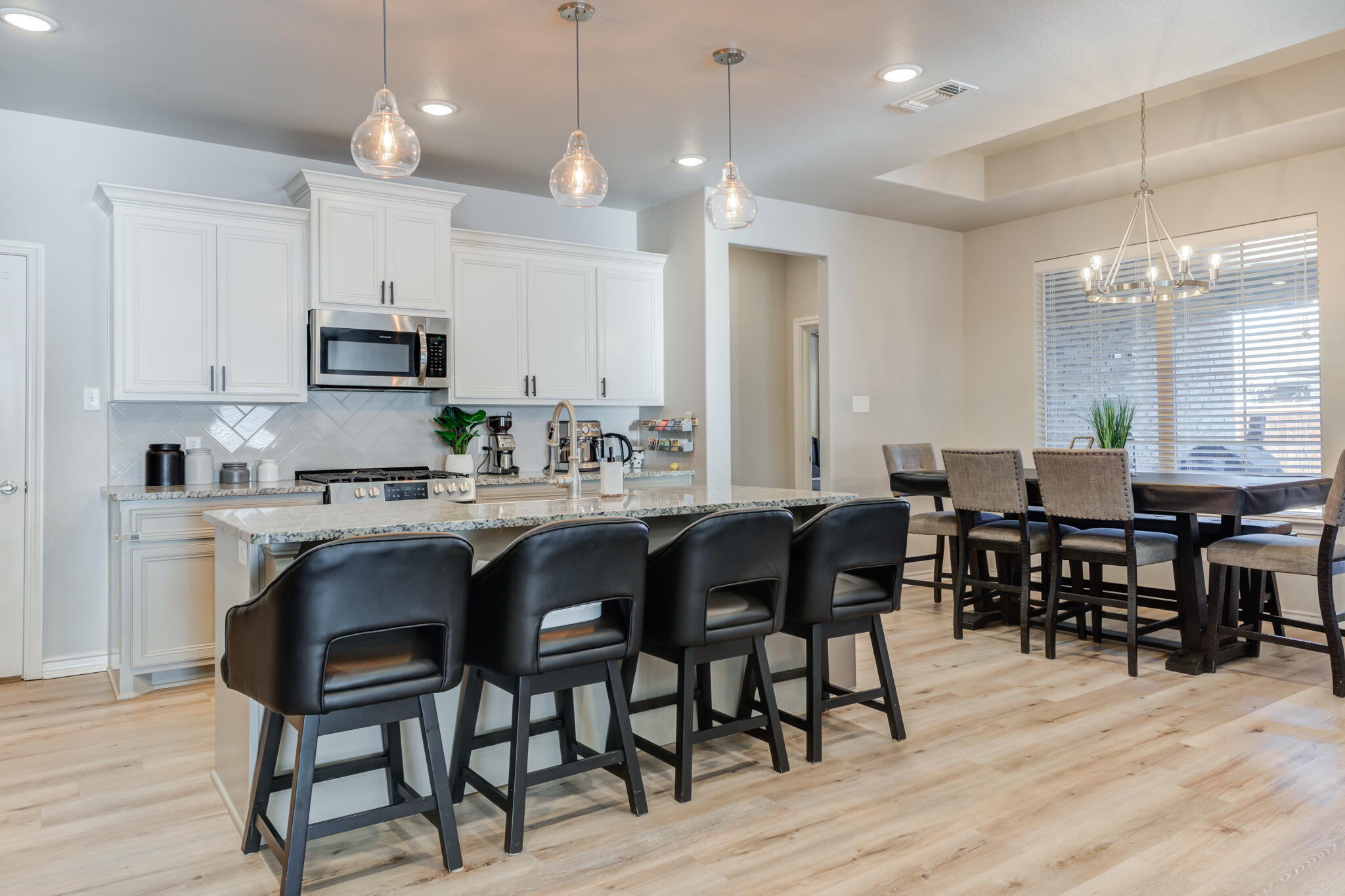 9609 Inverness Avenue Lubbock, TX 79424 - Photo 5 of 17 a large kitchen with a table and chairs