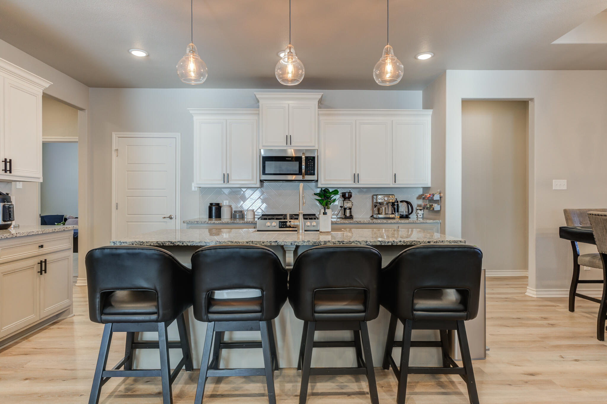 9609 Inverness Avenue Lubbock, TX 79424 - Photo 7 of 17 a kitchen with stainless steel appliances granite countertop a table chairs sink and cabinets