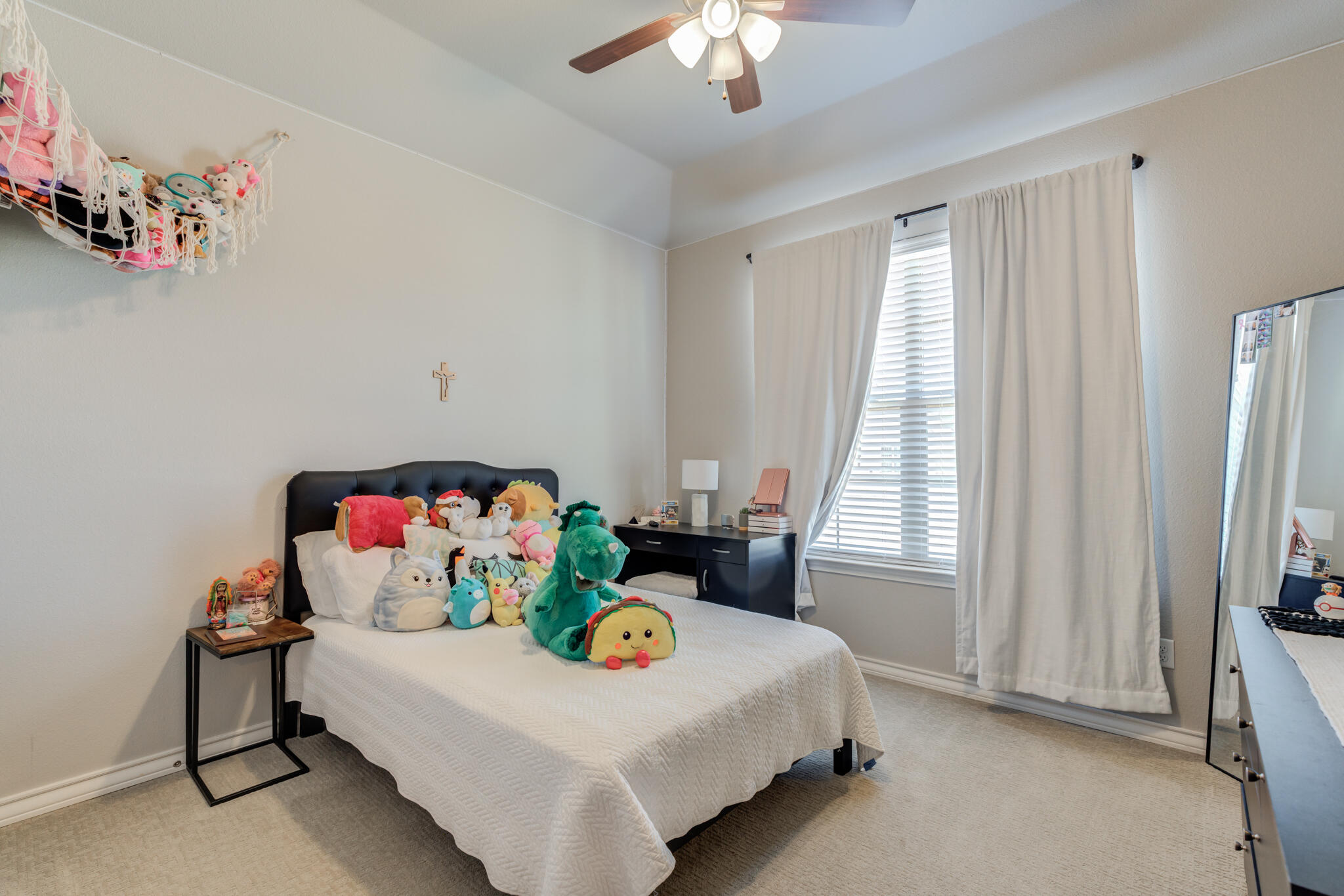 9609 Inverness Avenue Lubbock, TX 79424 - Photo 8 of 17 a bedroom with furniture and a chandelier