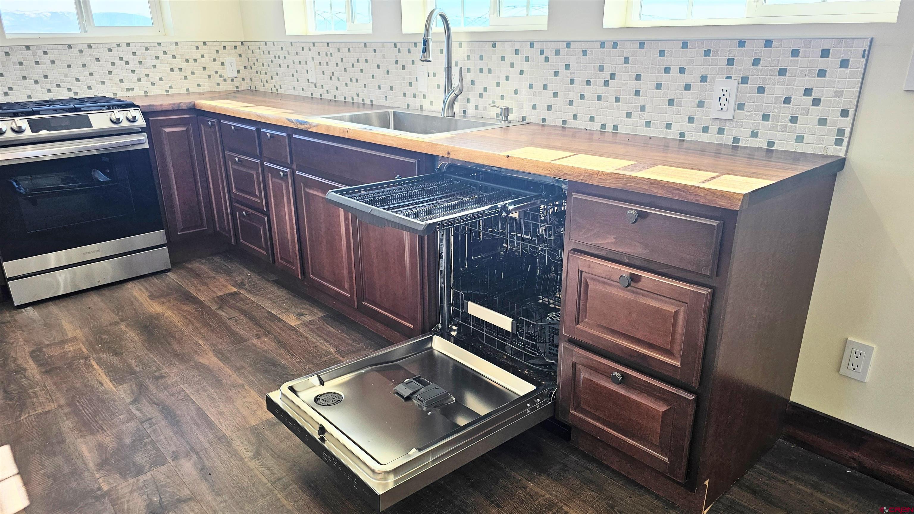 10547 Palm Road Blanca, CO 81123 - Photo 16 of 32 a kitchen with granite countertop a stove a sink and a microwave