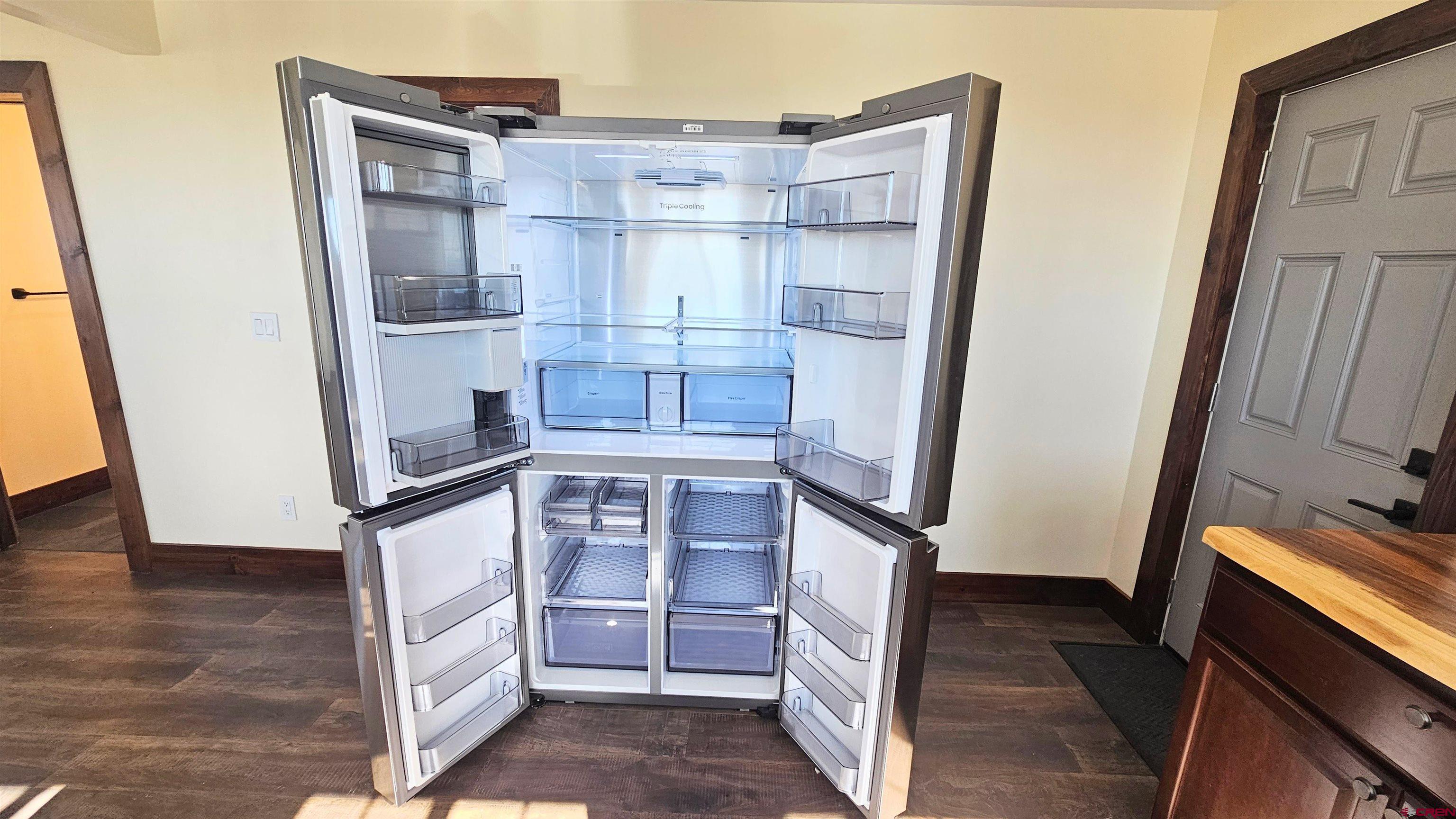 10547 Palm Road Blanca, CO 81123 - Photo 18 of 32 a view of walk in closet with an empty room and wooden floor