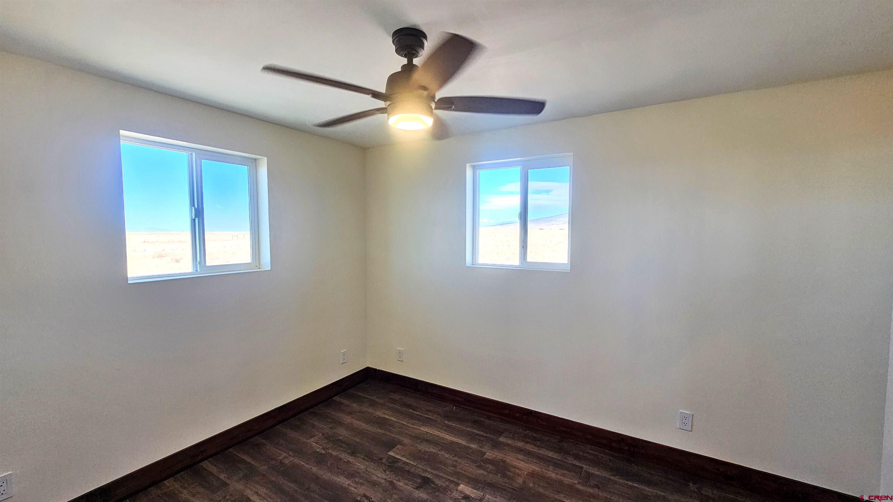 10547 Palm Road Blanca, CO 81123 - Photo 19 of 32 a view of an empty room with wooden floor and a window