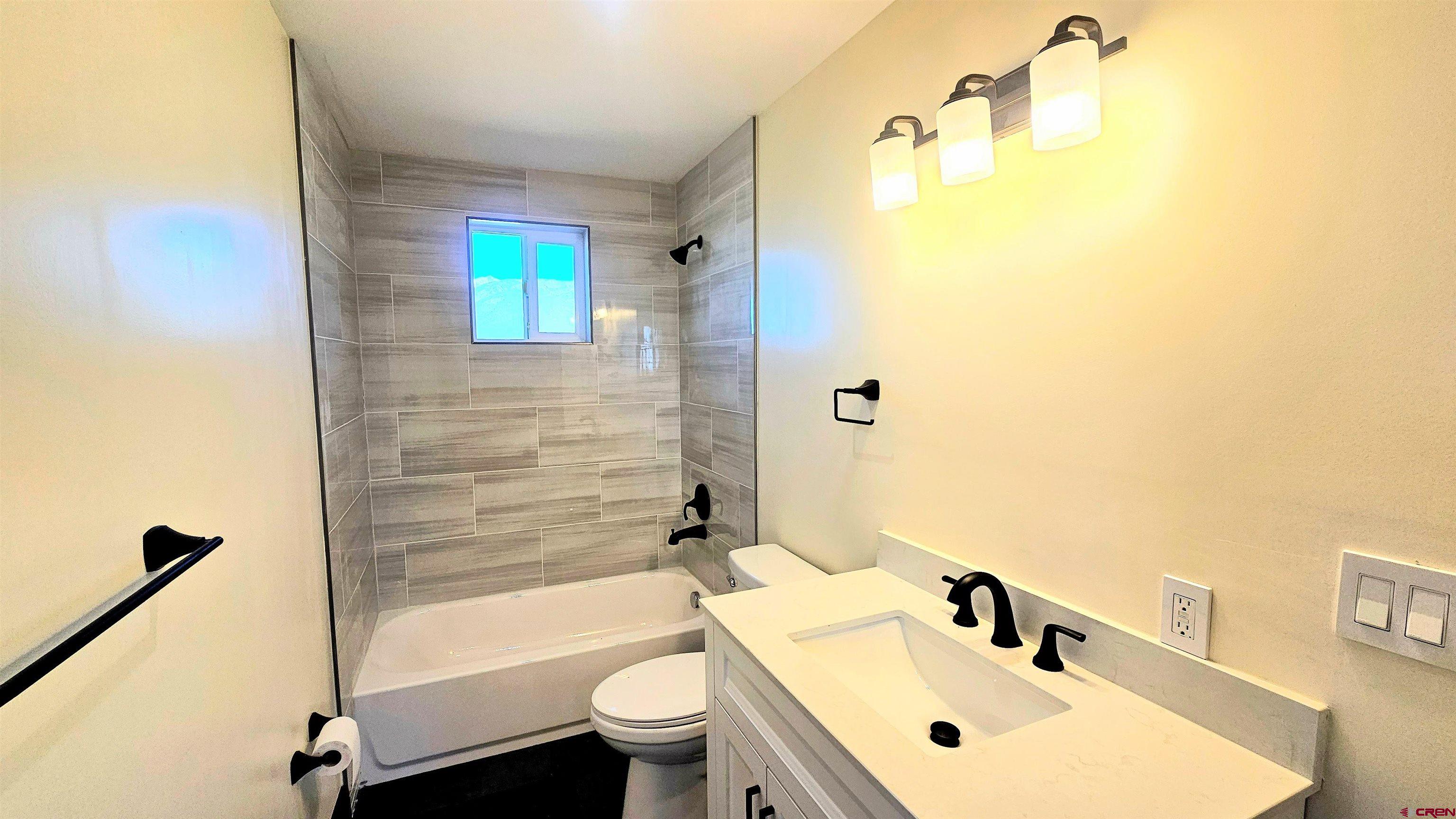 10547 Palm Road Blanca, CO 81123 - Photo 23 of 32 a bathroom with a sink mirror toilet and bathtub
