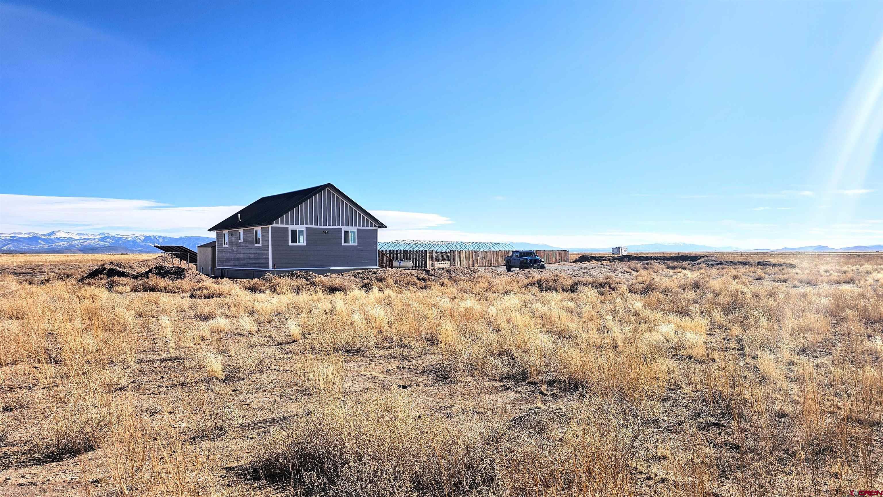 10547 Palm Road Blanca, CO 81123 - Photo 30 of 32 a view of a house with a yard