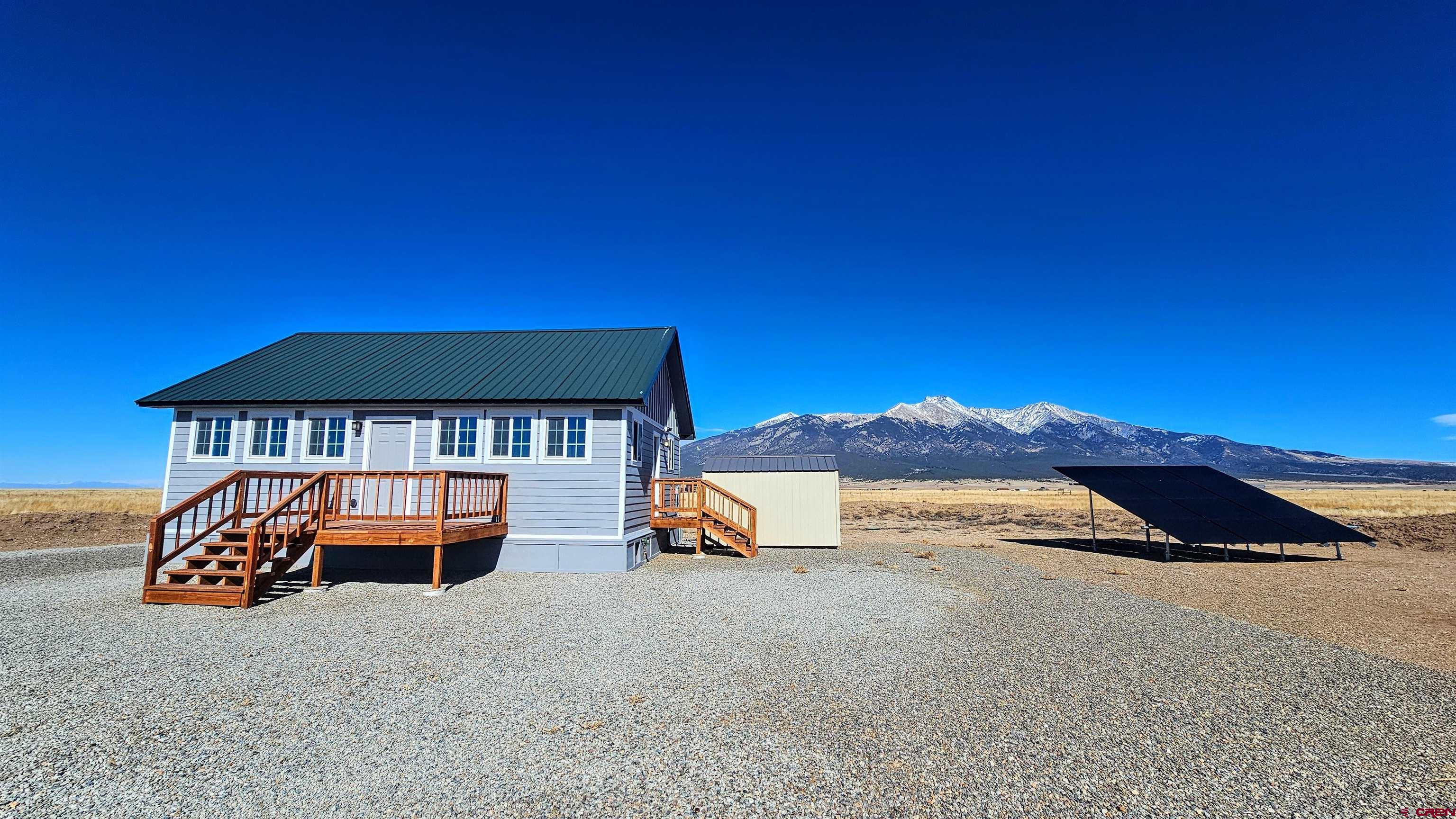 10547 Palm Road Blanca, CO 81123 - Photo 4 of 32 a view of a house with a yard and sitting area