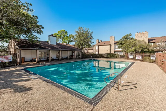 a view of a house with wooden fence