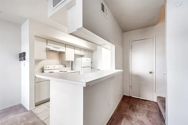 a kitchen with kitchen island a sink appliances and cabinets
