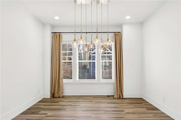 a bathroom with a sink a toilet a mirror and a window