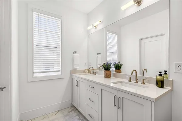 a bathroom with a sink vanity granite tub and shower