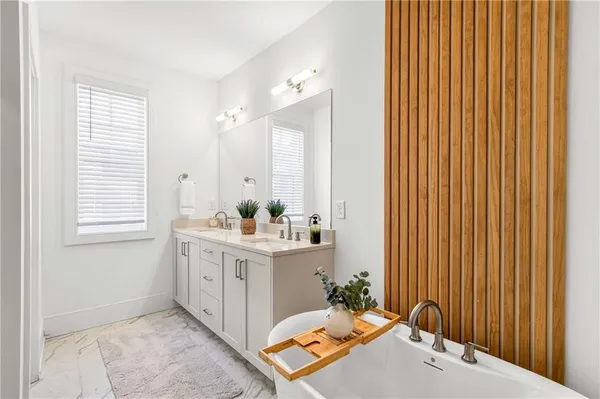 a white bath tub sitting next to a shower