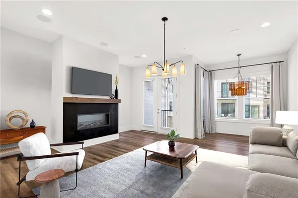 a view of empty room with wooden floor fireplace and window
