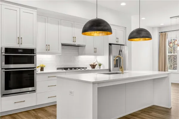a kitchen with a sink a stove and cabinets