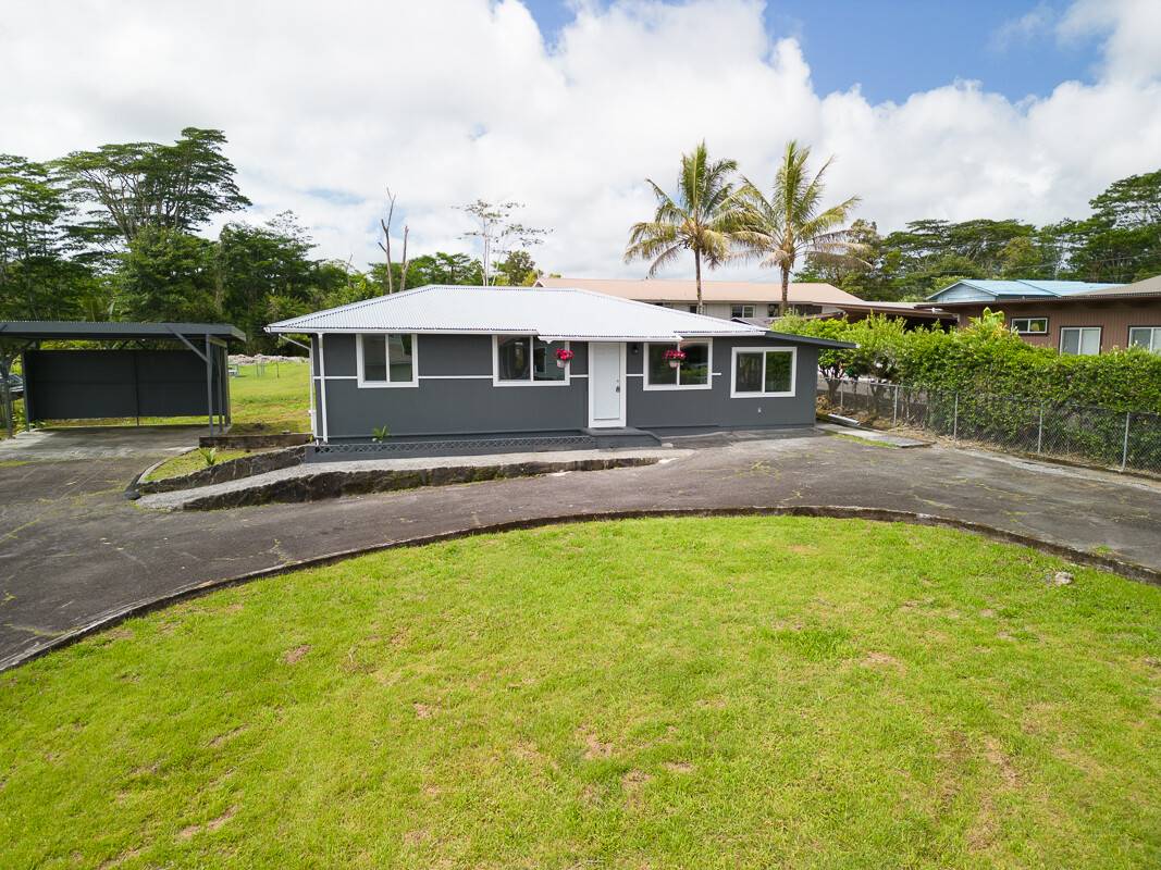 1907 Uhaloa Road Hilo, HI 96720 - Photo 1 of 23 a front view of a house with swimming pool garden and patio