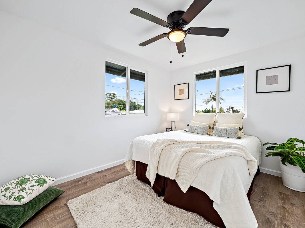 1907 Uhaloa Road Hilo, HI 96720 - Photo 11 of 23 a bedroom with a bed ceiling fan and a window