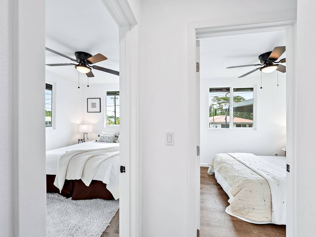 1907 Uhaloa Road Hilo, HI 96720 - Photo 12 of 23 a bedroom with a bed and a chandelier