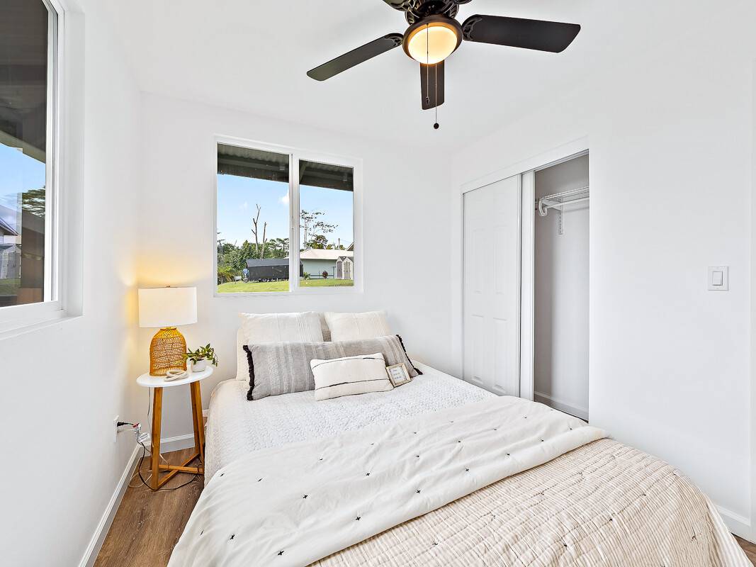 1907 Uhaloa Road Hilo, HI 96720 - Photo 13 of 23 a bedroom with a bed and a chandelier