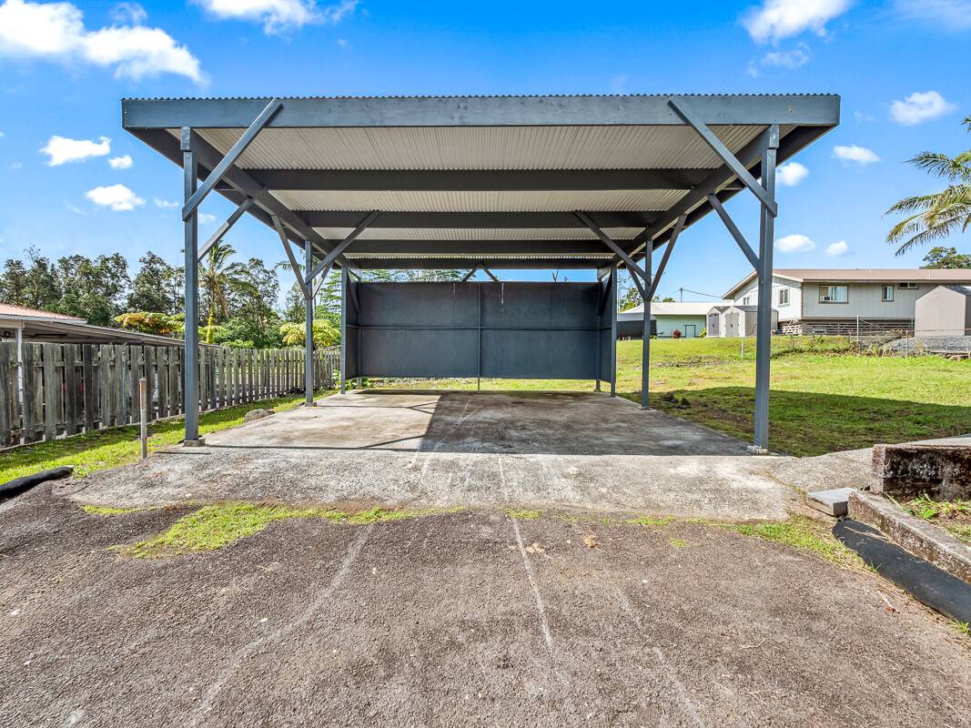 1907 Uhaloa Road Hilo, HI 96720 - Photo 17 of 23 a view of a backyard with wooden fence and a slide