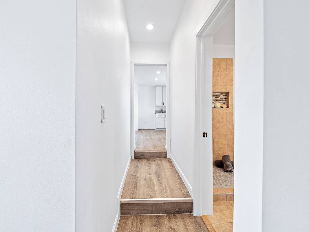1907 Uhaloa Road Hilo, HI 96720 - Photo 7 of 23 a view of a hallway with wooden floor and a bathroom