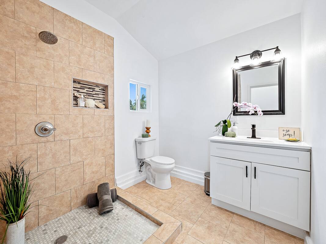 1907 Uhaloa Road Hilo, HI 96720 - Photo 8 of 23 a bathroom with a toilet sink and mirror