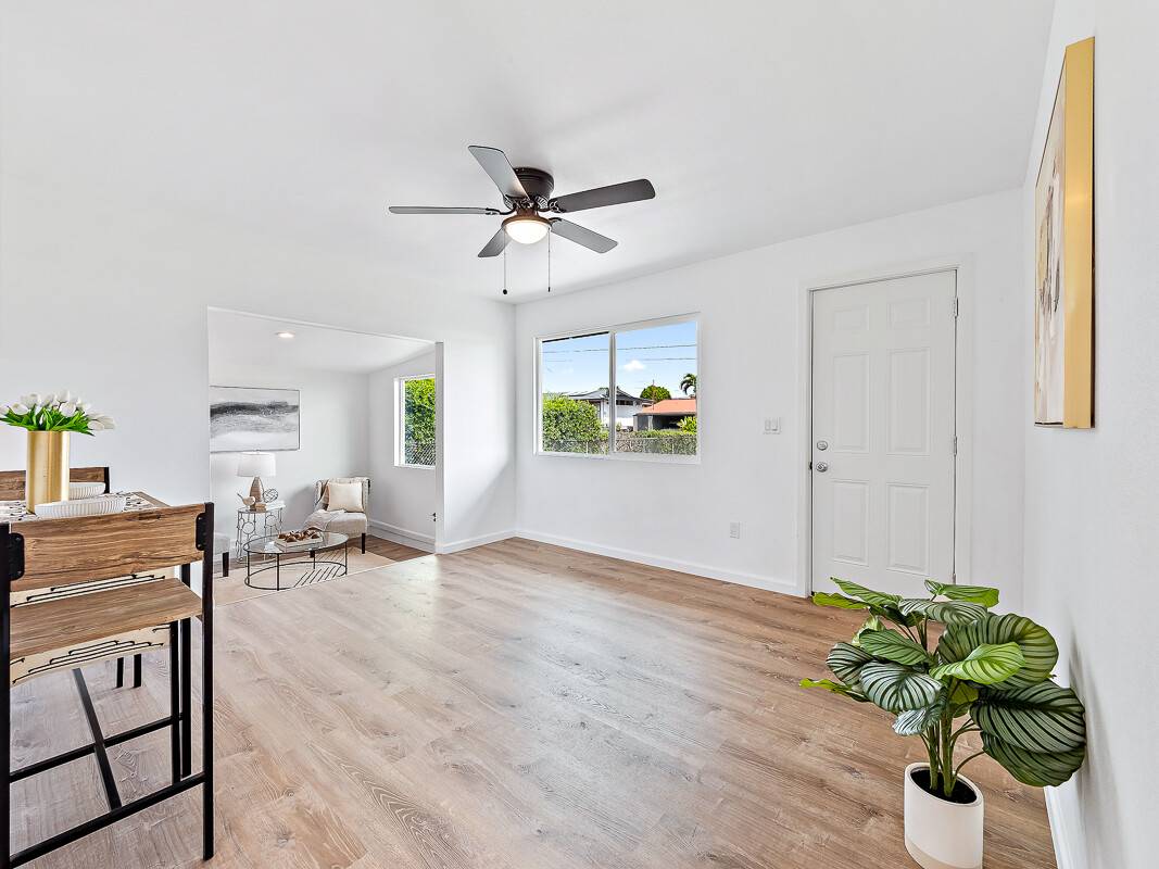 1907 Uhaloa Road Hilo, HI 96720 - Photo 9 of 23 a living room with furniture and a potted plant