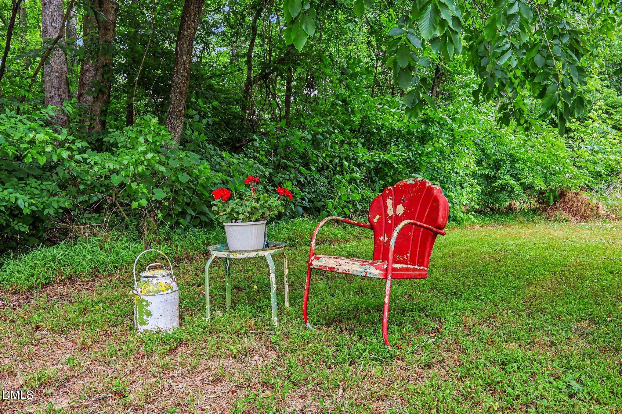 1750 Tom Oakley Road Timberlake, NC 27583 - Photo 28 of 31 a backyard with table and chairs and a small yard