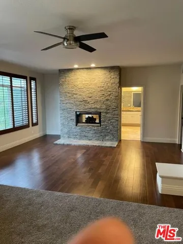 wooden floor in an empty room with a fireplace