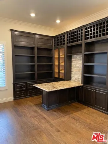 a bathroom with a granite countertop sink a mirror and bathtub