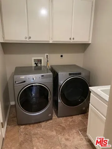 a bathroom with a granite countertop sink and a bathtub