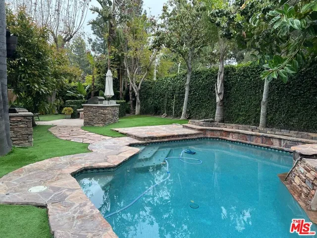 a view of a swimming pool with a patio
