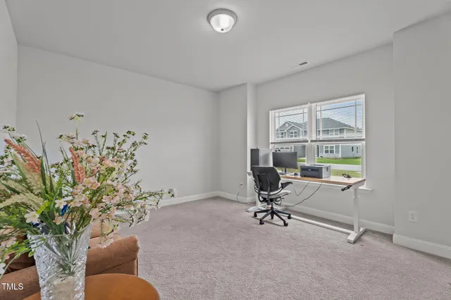 a livingroom with workspace and a window