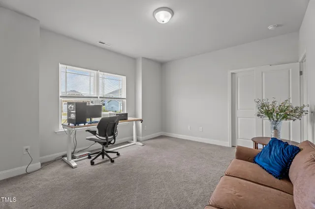 a view of workspace with a couch and a window