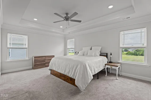 a spacious bedroom with a bed and a window