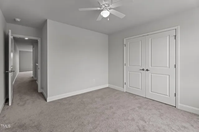 a view of an empty room and closet area