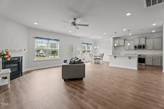 a living room with furniture and kitchen view